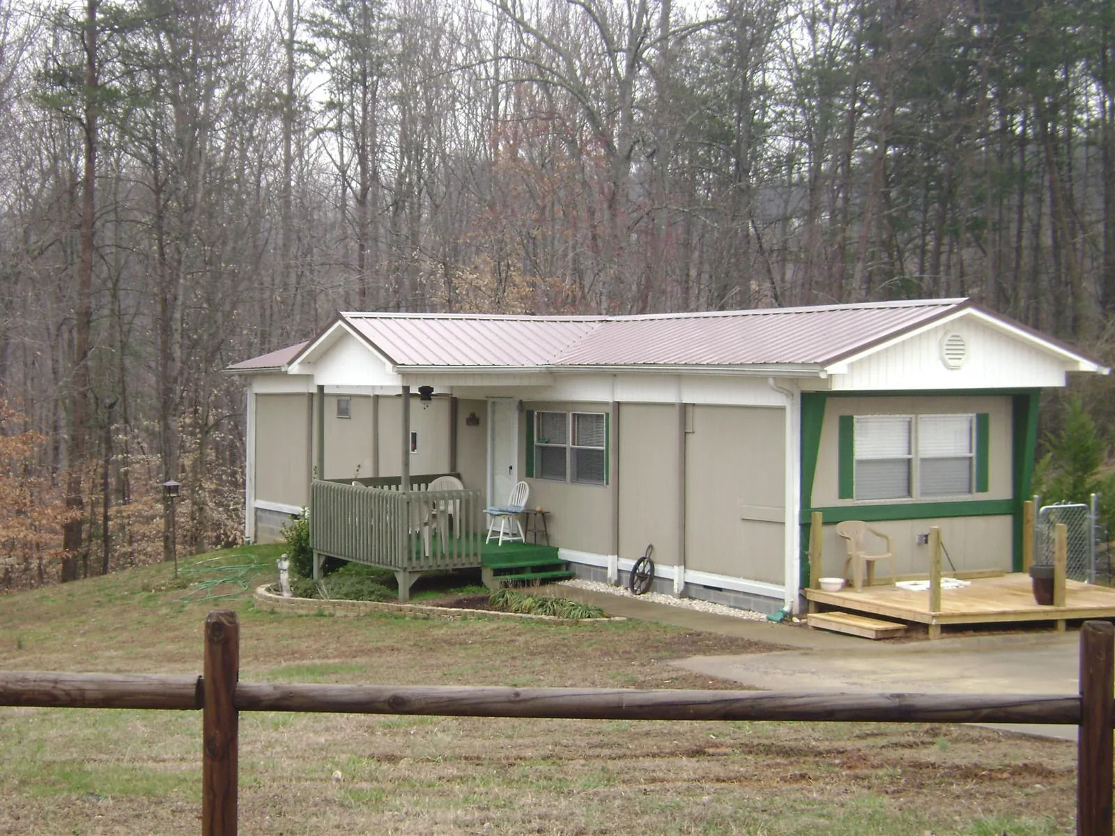 Mauve metal roof on a manufactured home with a new front deck in Niota